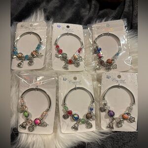 Charm Bracelet.3 Goldtone and 3 Silvertone random